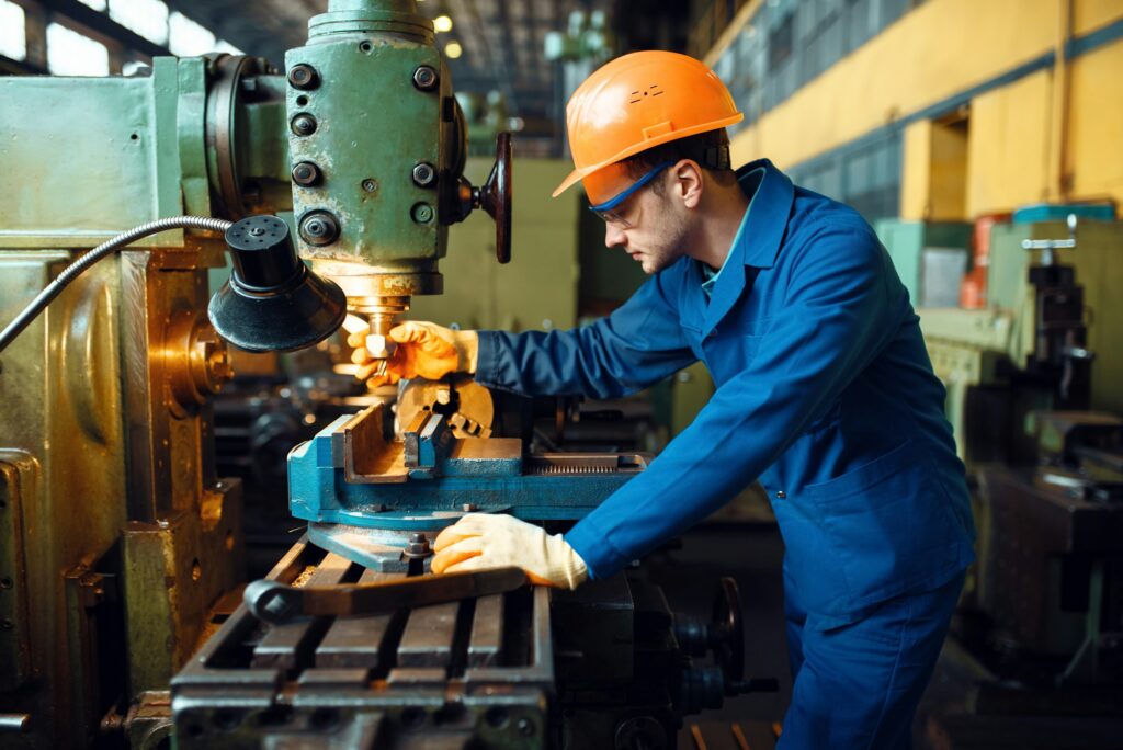 Male technician works on lathe, plant